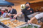 Vendors organize Chinese delicacies at a food stand of the Jade International Night Market held in Portland Community College campus in Southeast Portland, Ore., on Aug. 19, 2023.