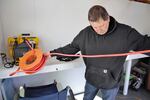 On April 25, 2023, Dan Haag prepares to blow the sand off the new wheelchair with an air hose.
