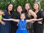 The author, Maria Godoy (second from right), with her sisters (from left): Monica Hanson, Elena Lynn and Olga Czekalski. Her daughter, Lily Hakim, is in front.