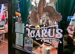 Customers gather inside to eat, chat and watch sports at Icarus Wings and Things in Salem, Ore., on Oct. 20, 2023. Icarus is a restaurant and bar dedicated to gluten-free food and women's sports.