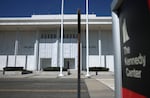 A photo of the entry to the Kennedy Center on Aug. 25, where a large hanging tarp remains in place across the facade, obscuring the name.