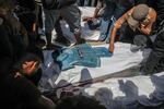 Palestinians mourn the death of journalists who were killed in an Israeli strike on Nasser Hospital in Khan Younis. Gaza's civil defense agency said five journalists were among at least 20 other people killed in the attack.