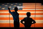 Children look at the Star Spangled Banner, the flag that inspired the lyrics of the American national anthem, at the Smithsonian's National Museum of American History, Tuesday, June 10, 2025, in Washington, D.C.