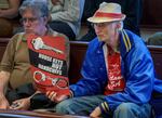 Opponents of a proposed camping ban hold a sign during testimony during a Portland City Council meeting in Portland, May 31, 2023. The proposal would ban camping from 8 a.m. to 8 p.m., and is aimed to deter homeless encampments.