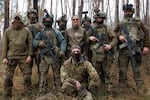 Yulia Brockdorf poses for a photo with soldiers of the Azov Brigade in Donetsk Oblast province on Nov. 15, 2023, before they begin a day of light weapons training in close-quarters battle trench warfare.