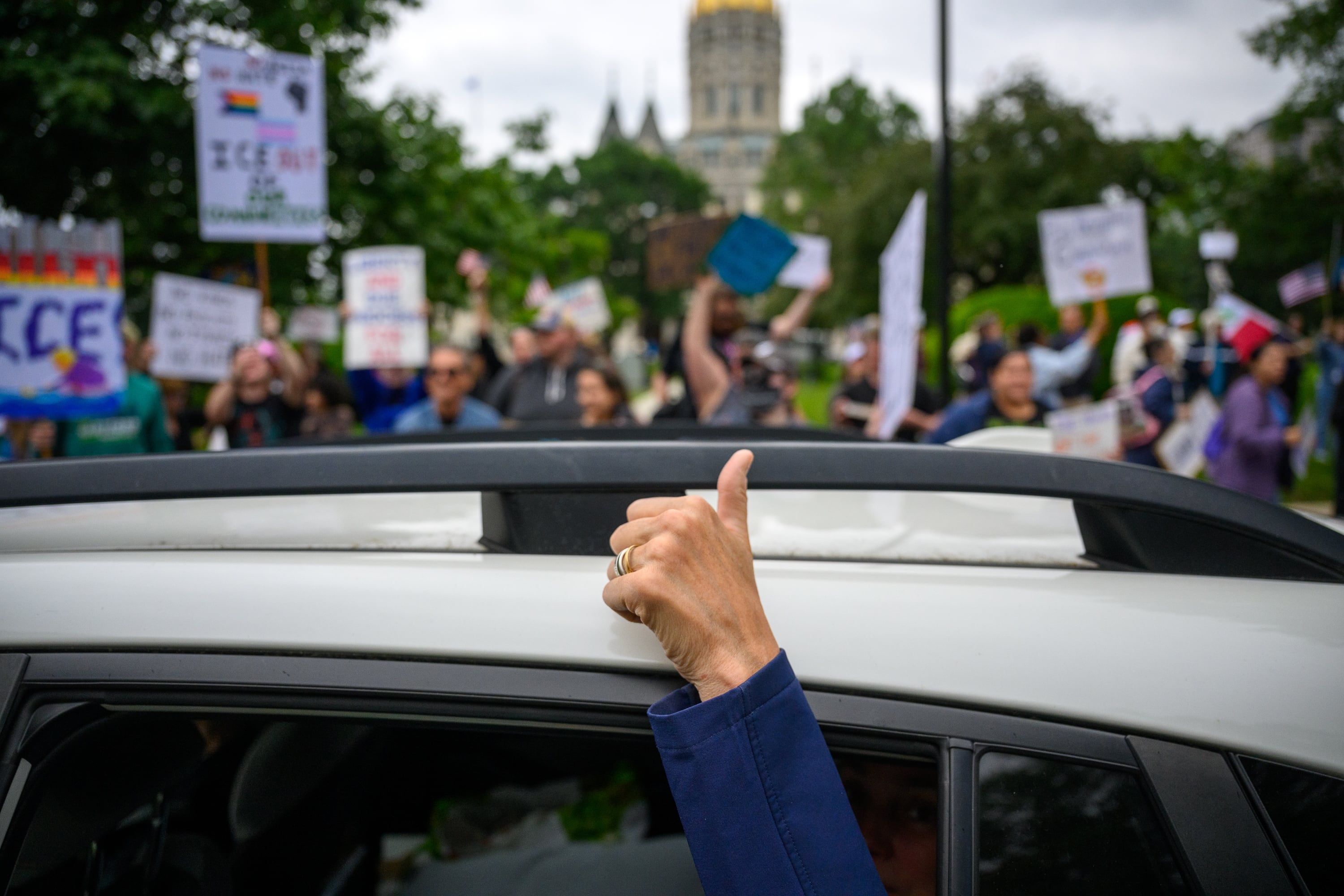 Hartford: A passenger in a car gives a sign of support for protestors at the Connecticut State Capitol.