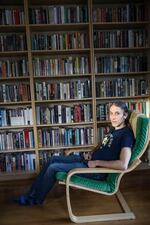 Garber at his home in front of his bookshelf. He owns an estimated 1,500 books.