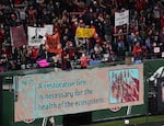 Thorns fans at Providence Park in Portland hold signs in dismay over the club's handling of sexual misconduct allegations.