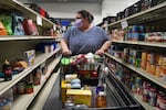 Heather Thomas browses the aisles of the Western Fairfax Christian Ministries food pantry in Chantilly, Va., last month.