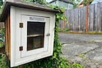 A Little Free Library box that has been repurposed as a Little Free Pantry (micropantry) at Pine and NE 27th Avenue..