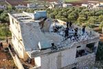 People inspect a destroyed house following an operation by the U.S. military in the Syrian village of Atmeh, in Idlib province, Syria, Thursday, Feb. 3, 2022. U.S. special operations forces conducted a large-scale counterterrorism raid in northwestern Syria overnight Thursday, in what the Pentagon said was a "successful mission." Residents and activists reported multiple deaths including civilians from the attack.