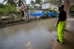A worker of the Loiza municipality calls on residents to evacuate due to imminent flooding due to the rains of Hurricane Fiona, in Loiza, Puerto Rico.