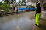 A worker of the Loiza municipality calls on residents to evacuate due to imminent flooding due to the rains of Hurricane Fiona, in Loiza, Puerto Rico.