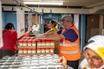 Volunteers, many of whom use the food bank, hand out food to clients at the Ecumenical Ministries of Oregon’s Northeast Emergency Food Program in Portland, Ore., on Tuesday, Oct. 21, 2025.