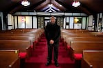 Rev. David Bigsby poses for a photo at his church in Lansing, Ill., Tuesday, Jan. 20, 2022. He moved to Lansing, Ill., 6 years ago, his predominantly Black church has grown in that time by at least 20%.