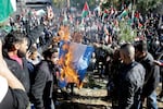 Palestinian refugees burn an Israeli flag during a demonstration at the Jaramana Camp on the edge of Damascus, Syria, in 2017. At that time, they were protesting President Trump’s decision to move the U.S. Embassy in Israel from Tel Aviv to Jerusalem. Today, they are opposed to Trump’s call for Gaza residents to be relocated.