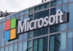 FILE - This April 12, 2016, file photo shows the Microsoft logo in Issy-les-Moulineaux, outside Paris, France. Russia, China and Iran are expanding their partnerships with cyber criminals to conduct cyberespionage and cyberattacks against the U.S. and other nations, according to a new report from Microsoft. Analysts at the tech giant say partnerships between authoritarian governments and criminal networks have benefits for both sides, increasing the volume and effectiveness of the cyber operations while giving criminals new avenues to profit and protection from prosecution. (AP Photo/Michel Euler, File)