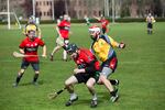 Enda Grogan, center, spins in attempt to get by Scott Meyers, right, a Red Branch player dressed for the opposing side.