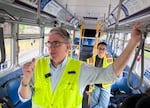 Tom Mills rides in a test bus with TriMet community affairs representative Carina Solis when considering changes to a route.