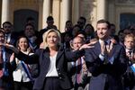 French far-right leader Marine Le Pen, left, reacts with Jordan Bardella during the French far-right party national rally near the parliament in Paris on Sunday.