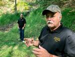 Dennis Parada, right, and his son Kem Parada stand at the site of the FBI's dig for Civil War-era gold in September 2018 in Dents Run, Penn. A scientific report commissioned by the FBI shortly before agents went digging for buried treasure suggested that a huge quantity of gold was below the surface.