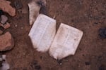 A burned Christian text is seen on the ground in Yelwata in mid-June.