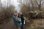 In this March 13, 2026 photo, Greenbelt Land Trust's Kendra Callahan (foreground center) looks at the beaver pond along the Bald Hill Multi-Use Path along with others representing groups that worked on the notch exclusion fence.