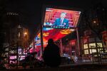 A news report of Xi Jinping, China's president, at the National People's Congress is displayed on a screen in Beijing.