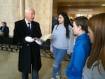 Oregon Secretary of State Dennis Richardson shows off the original state constitution to visitors at the Oregon Capitol. 
