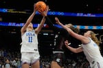 UCLA guard Gabriela Jaquez (11) grabs a rebound over South Carolina guard Tessa Johnson (5) during the second half of the women's National Championship Final Four NCAA college basketball tournament game, Sunday, April 5, 2026, in Phoenix.