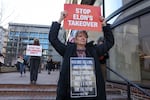 Demonstrators raise signs and posters at a rally to protest the closing of the Consumer Financial Protection Bureau (CFPB) on Feb. 10, 2025 in Washington, DC.