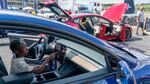 A young attendee examines a Tesla car during the Electrify Expo in Washington D.C. on July 23, 2023. The expo highlighted new and soon-to-be-released electric cars, bikes and other technology. Companies are racing to bring more vehicles to market, in a wider range of segments and at lower prices, to win over skeptical car shoppers. Tesla is working on a lower-cost next-generation platform.