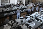 Workers prepare electronic voting machines during a sealing operation before Brazilian presidential elections in Brasília on Sept. 21.