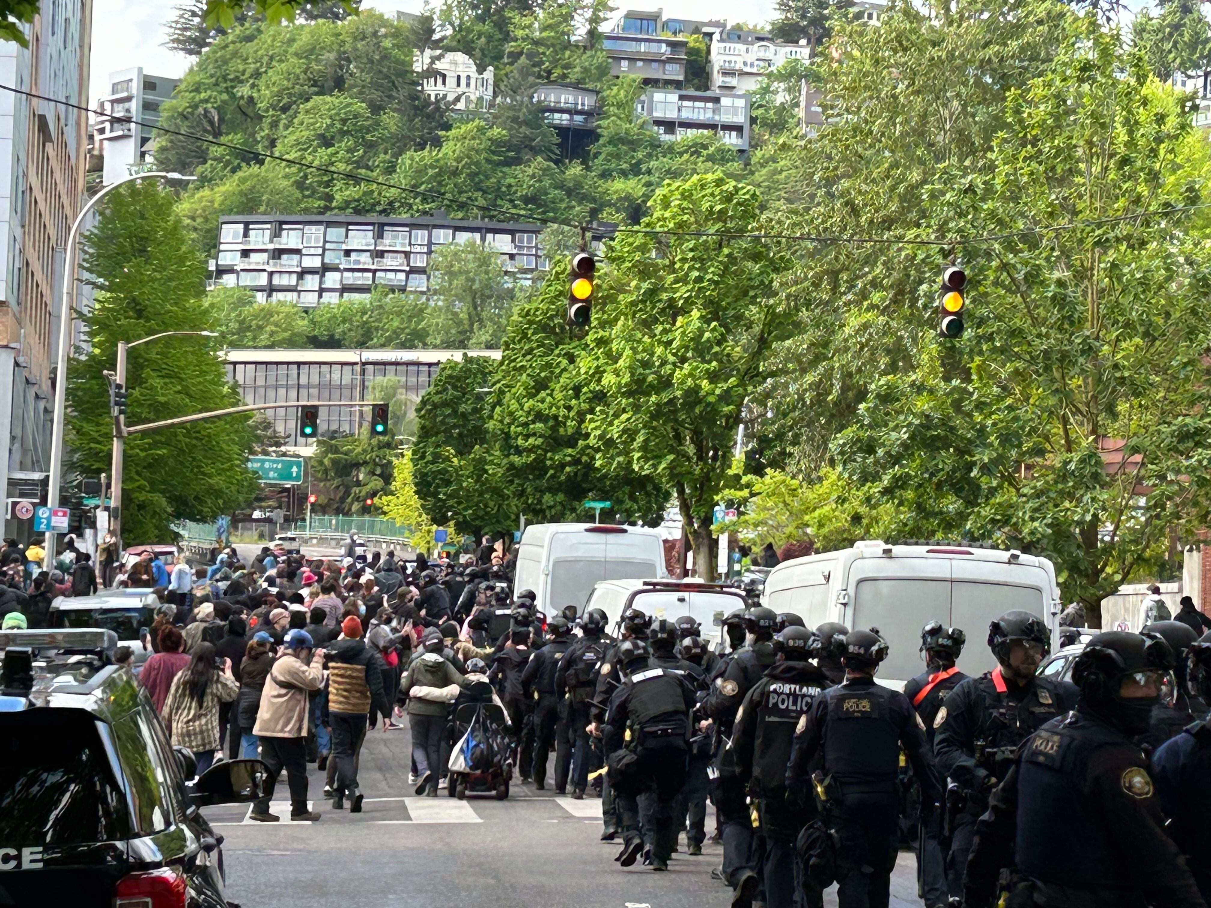 Portland police form a perimeter around the Portland State University campus on Thursday, May 2, 2024, as people converge on the area to object to the arrest of protesters occupying the school's library.