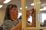Carlotta Lane, Confederated Tribes of Siletz Indians, started weaving back in the 1980s, but this was her first time working a loom. By the end of the conference, she had woven a purple and cream-colored wool headband. “I do basket weaving for my tribe, but this is something new for me. It’s a challenge and something I needed,” she said.