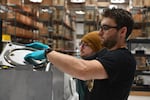 Helion employees assemble a capacitor for one of the company's machines.