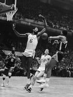 Russell tries to swat away a pass by Fred Crawford of the New York Knicks in 1967.