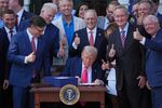 President Trump signs his signature bill of tax breaks and spending cuts at the White House on July 4.