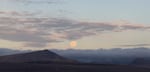 A morning moonrise on Christmas Valley with a clouds.