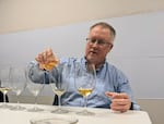 Tom Collins tests smoke-tainted spirits at the WSU Wine Science Center in Richland, Wash.