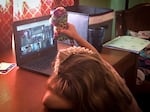 Five-year-old Abby Bucolo attends her kindergarten classes online, weeks after the Almeda Fire destroyed her home.