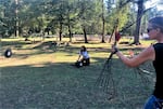 Beesh Lotspeich shoots a small target tossed into the air by Elise Kelly, another horse archer, as part of their friendly competition and training drills to develop the skills needed for competitive horse archery.