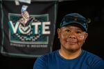 Kevin Jackson poses for a portrait in his vendor booth at the Phoenix Indian Center’s Social Powwow and Gourd Dance.