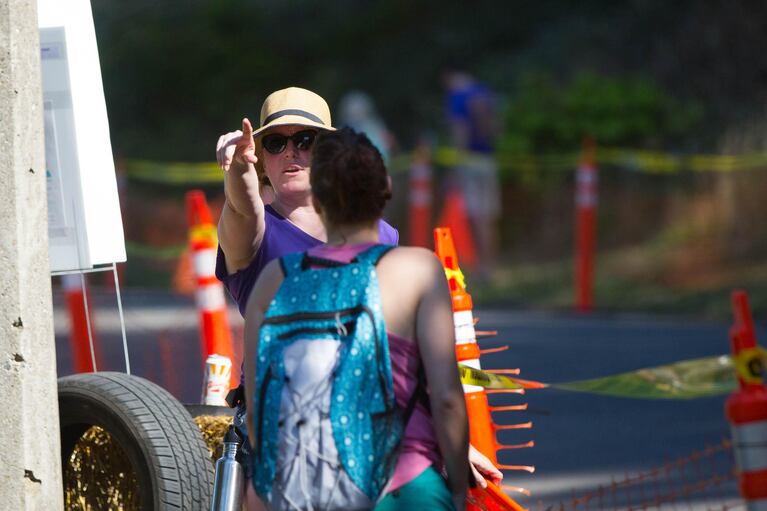 A volunteer gives directions to a spectator. The large team of volunteers at the derby tend to the famed course, keeping viewers away from the track.