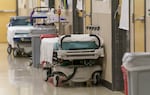 Hospital beds are parked in the hallways of the Salem Health emergency department on Jan. 27, 2022, a way for the busy hospital to accomodate the recent surge of coronavirus. The Oregon Association of Hospitals and Health Systems warned on Wednesday that without considerable support from the state, hospitals may need to cut beds or services to meet their budgets.