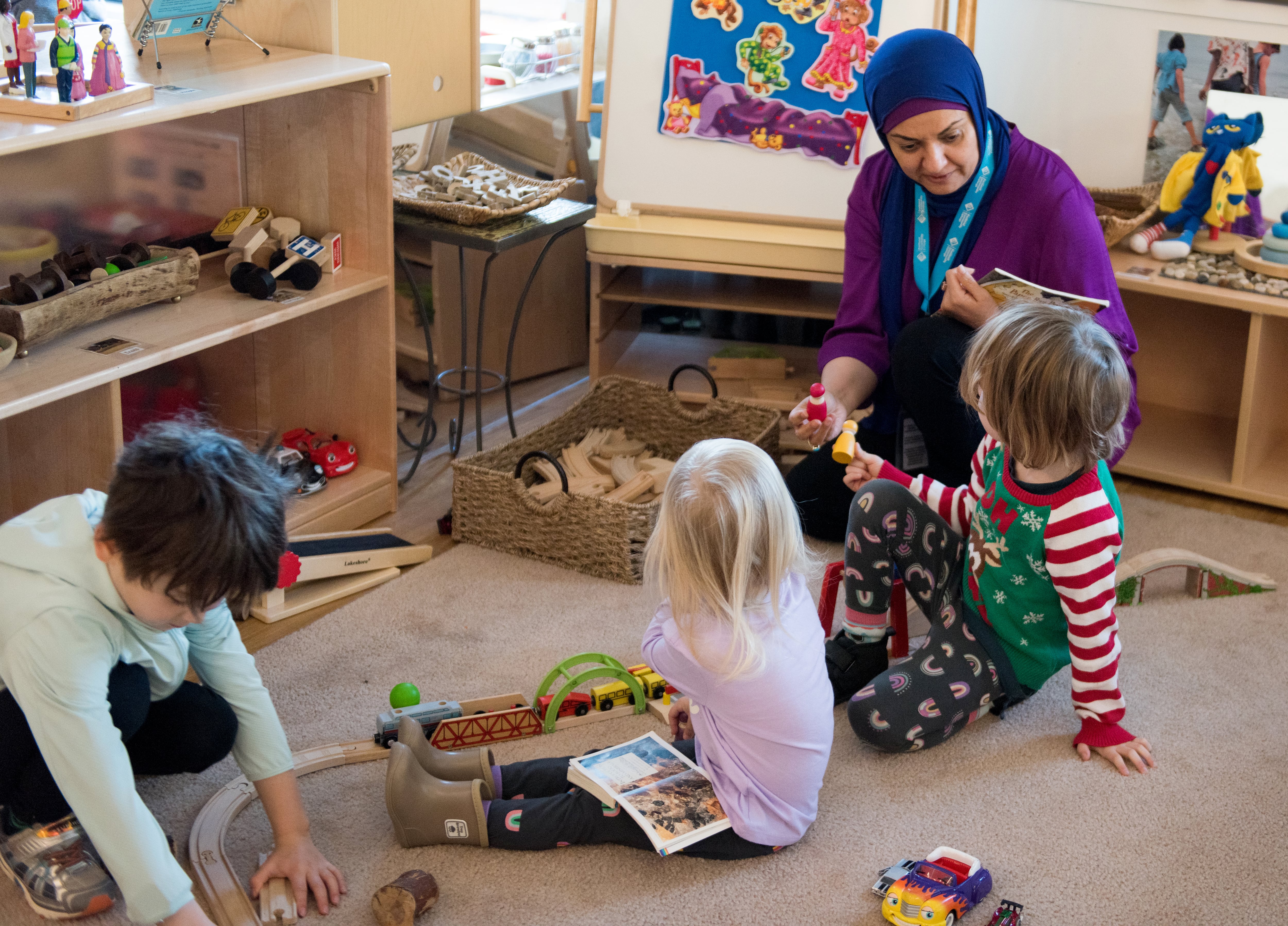 Children play with a teacher at Portland Community College's Child Development Center in October 2024. The center is partially funded by the Child Care Access Means Parents in School grant.