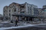 A man walks down a war-ravaged street in Pokrovsk, an industrial city in eastern Ukraine's Donetsk region, on Dec. 19, 2024. Behind him is the hotel Druzhba, which was destroyed by a Russian missile last summer. Pokrovsk was once home to 60,000 people. Now it's largely abandoned, with Russian troops active within a mile of the outskirts.