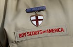A close up of a Boy Scout uniform is photographed on Feb. 4, 2013, in Irving, Texas. On Tuesday, March 28, 2023, a federal district court judge upheld the approval of a $2.4 billion bankruptcy reorganization plan aimed at resolving tens of thousands of child sexual abuse claim against the Boy Scouts of America.