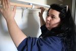 Abby Hartung inspects a closet she helped build.