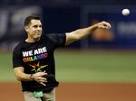 Bill Bean, MLB's vice president of Social Responsibility and Inclusion, throws out the ceremonial first pitch before a baseball game between the Tampa Bay Rays and the San Francisco Giants in 2016 in St. Petersburg, Fla.